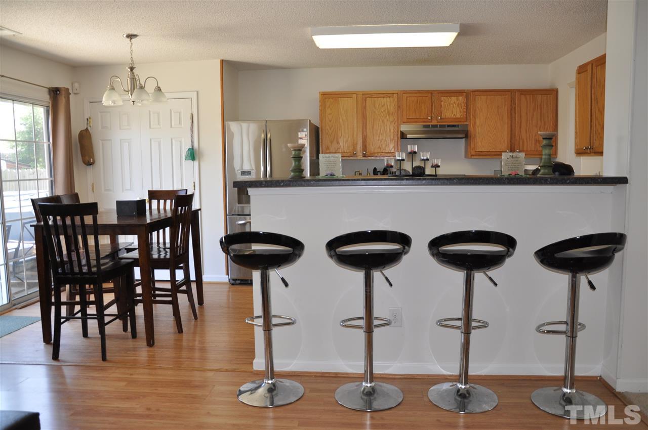 3305 Marcony Way Raleigh, NC 27610 - Photo 5 of 25 a kitchen with lots of counter space and chairs