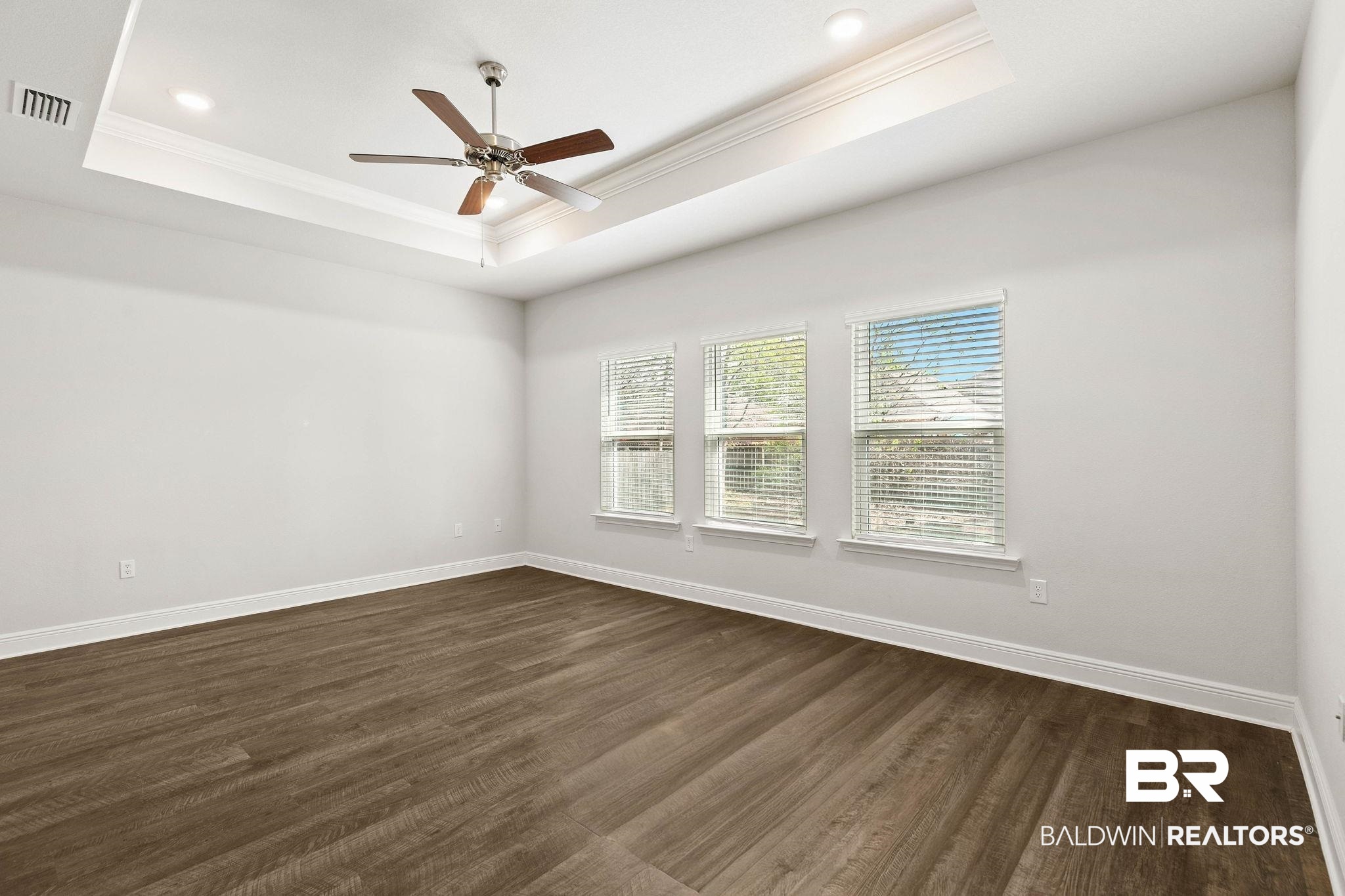 9448 Amethyst Drive Daphne, AL 36526 - Photo 23 of 61 Spare room with a ceiling fan, crown molding, and dark wood finished floors