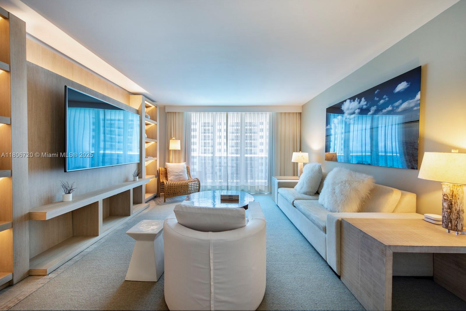 102 24th Street, Unit 1012 Miami Beach, FL 33139 - Photo 11 of 18 a living room with furniture and a large window