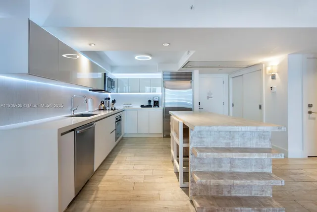 a kitchen with granite countertop a sink and cabinets