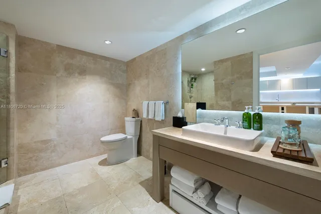 a room with a sink and chairs