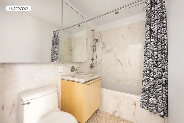 a living room with furniture flat screen tv and a large window