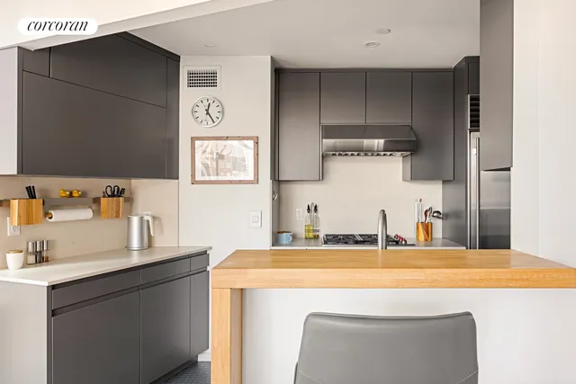 a kitchen with a refrigerator and a sink