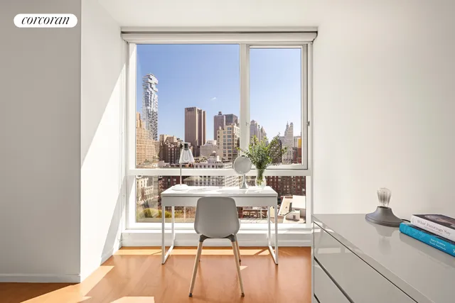 a bedroom with furniture and a wooden floor