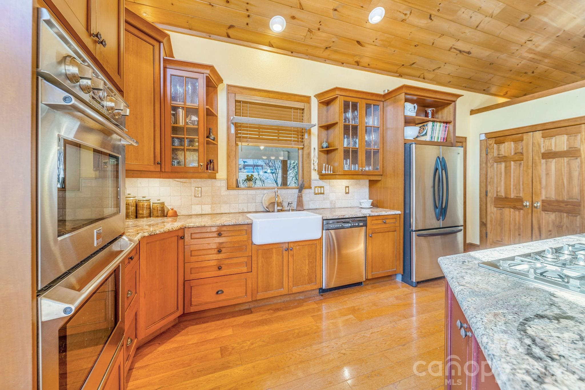 22 Mountain Spring Lane Canton, NC 28716 - Photo 16 of 48 a large kitchen with stainless steel appliances granite countertop a sink and cabinets