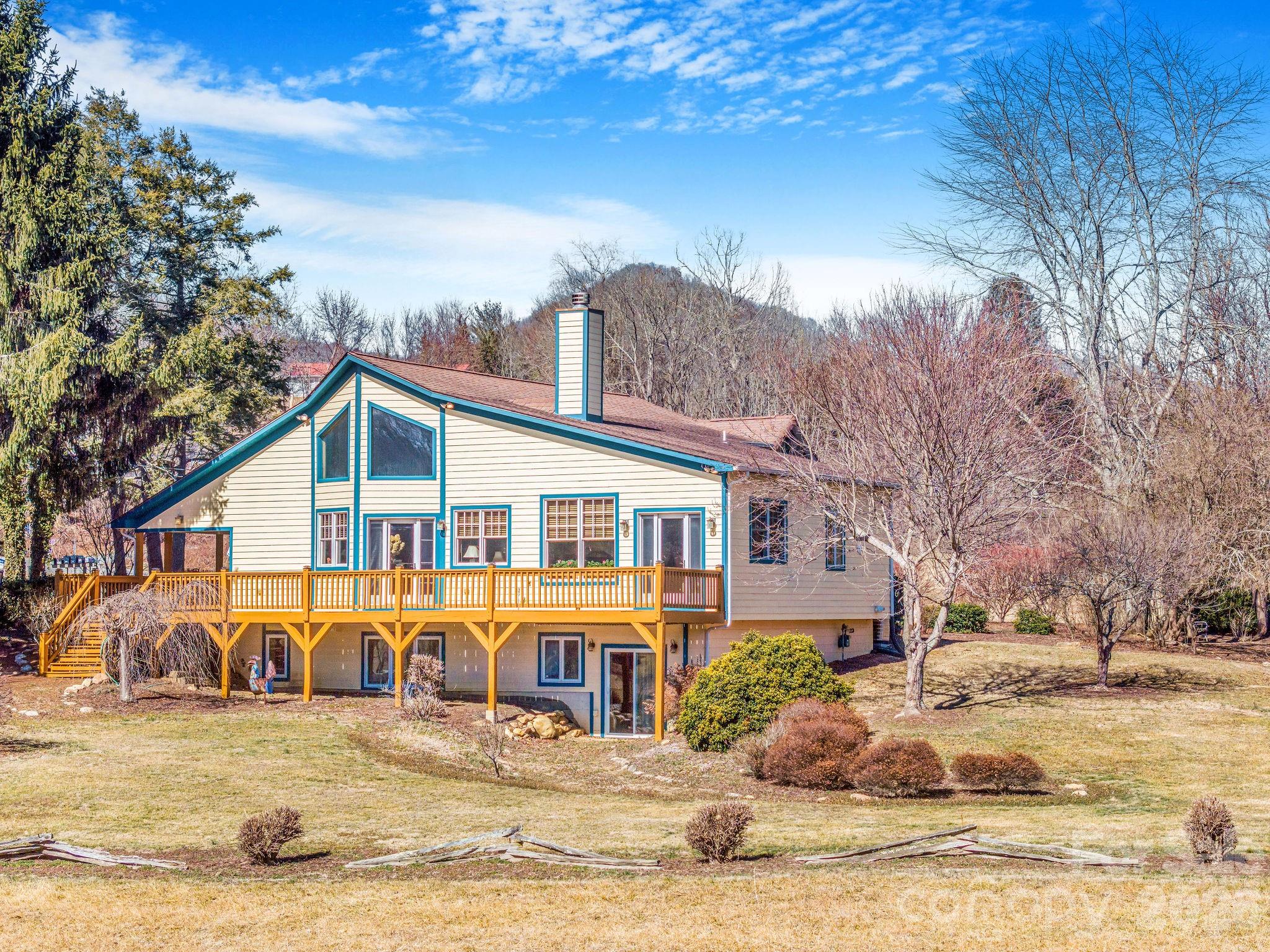22 Mountain Spring Lane Canton, NC 28716 - Photo 2 of 48 a front view of a house with a yard covered with snow and trees