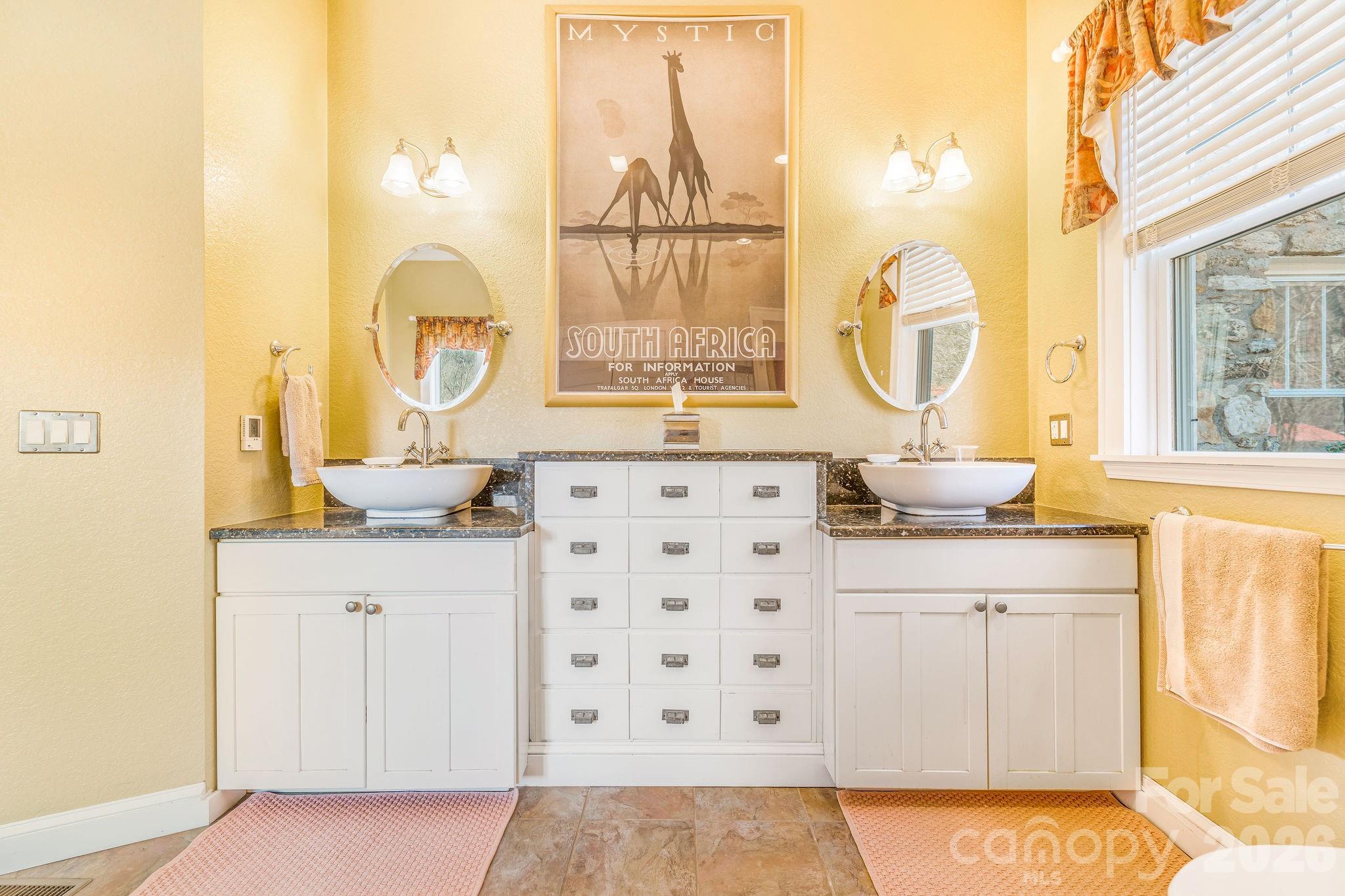 22 Mountain Spring Lane Canton, NC 28716 - Photo 25 of 48 a bathroom with a sink a vanity and a large mirror