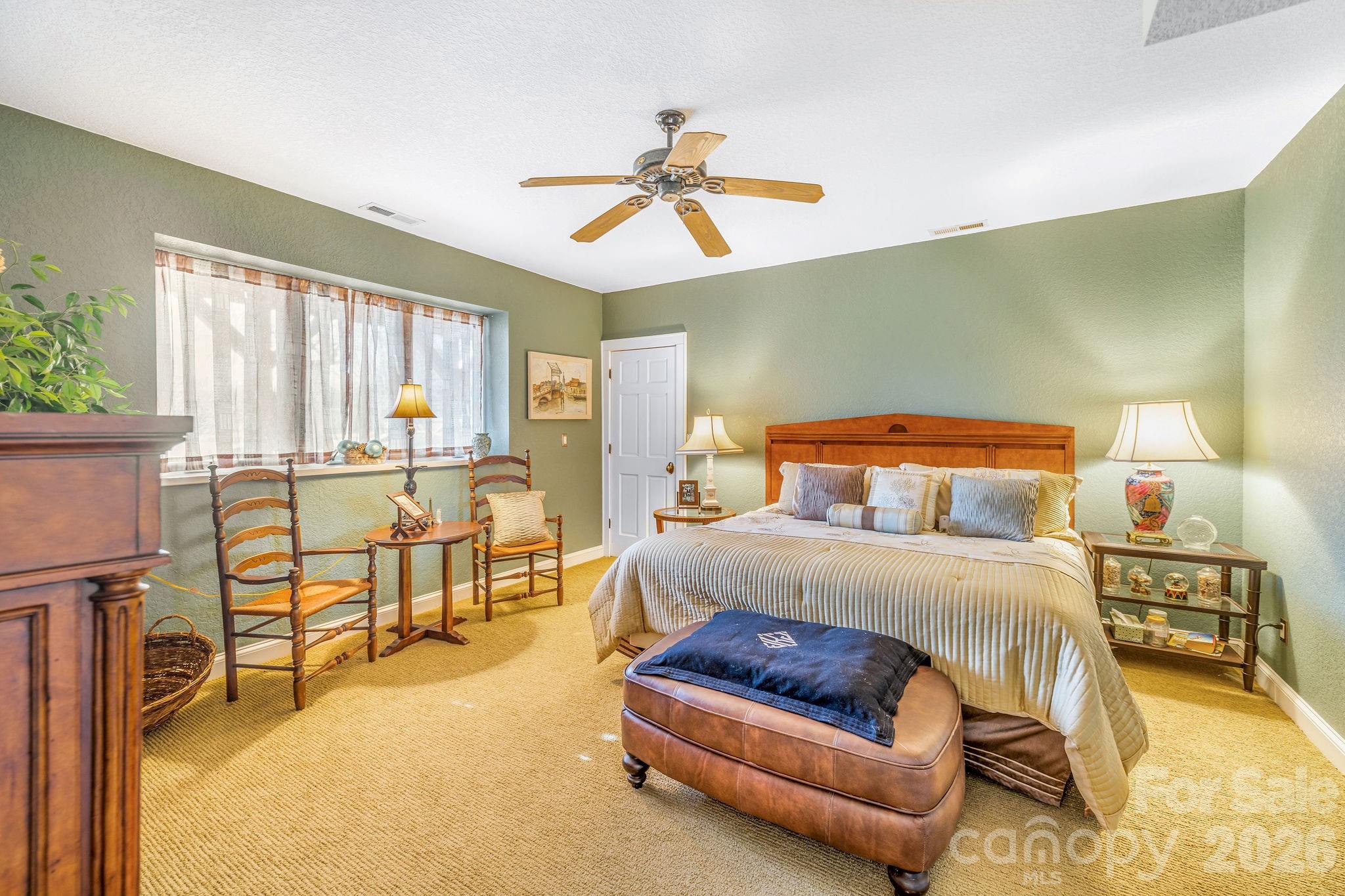 22 Mountain Spring Lane Canton, NC 28716 - Photo 39 of 48 a bedroom with a bed and a chandelier