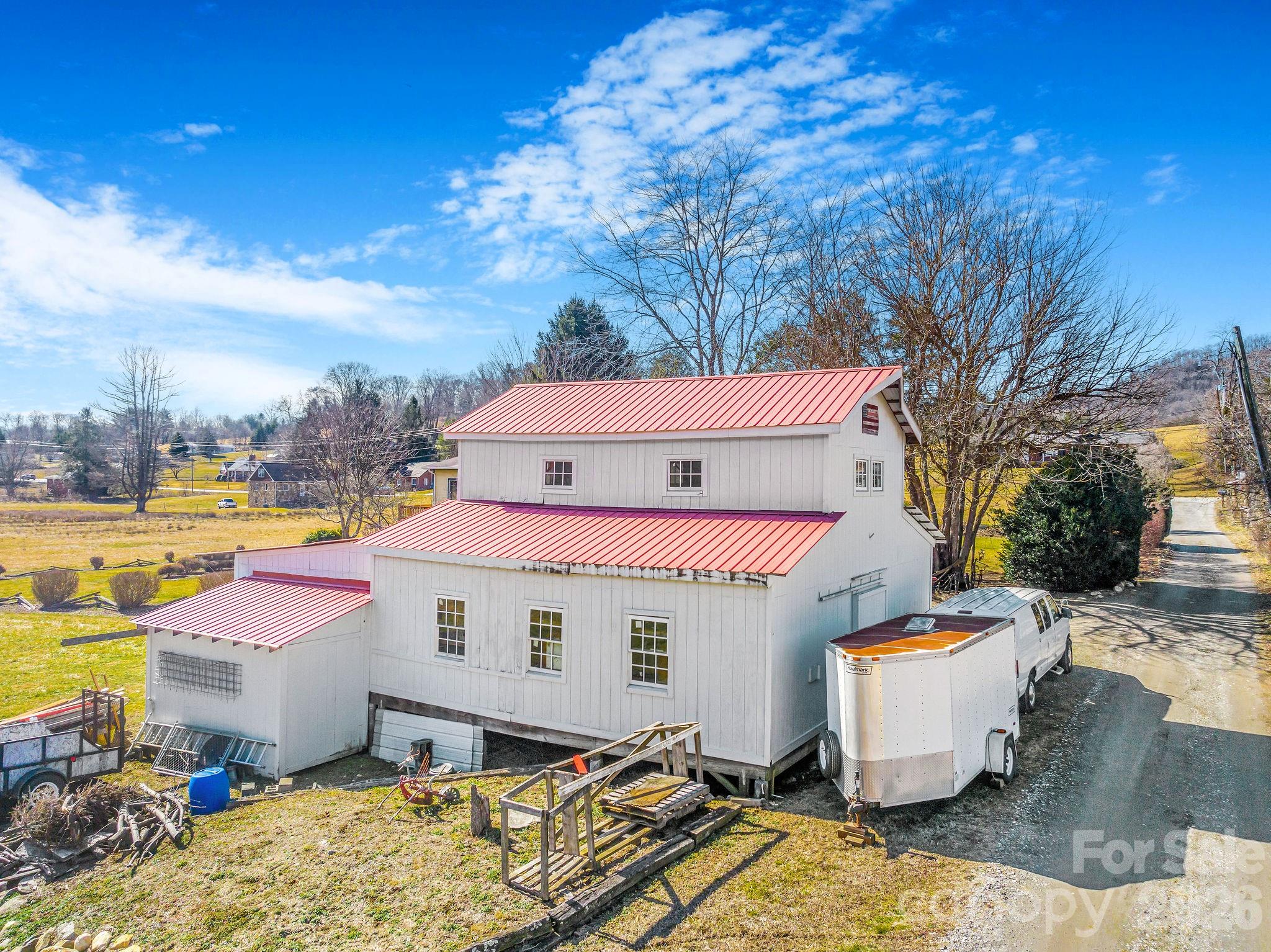 22 Mountain Spring Lane Canton, NC 28716 - Photo 47 of 48 a view of a white house with a yard and sitting area