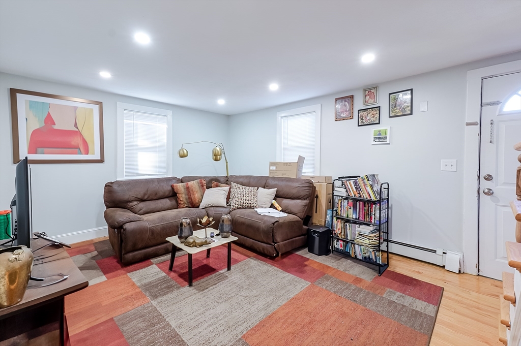 5 Oliver Street Randolph, MA 02368 - Photo 17 of 29 a living room with furniture and wooden floor