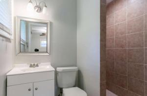 3409 Hyland Drive Decatur, GA 30032 - Photo 14 of 18 a bathroom with a toilet sink vanity and mirror