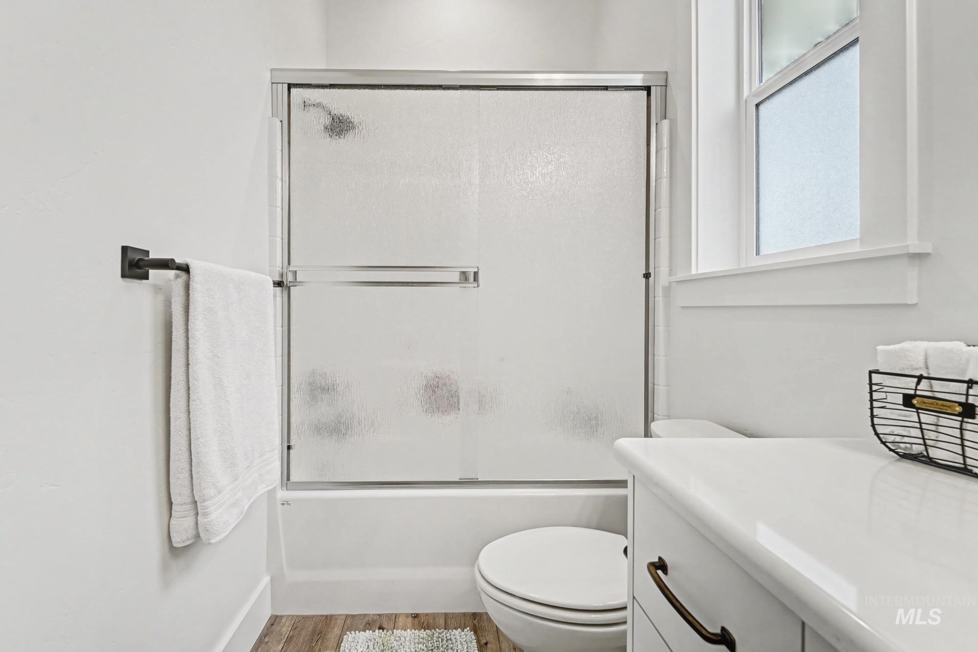 18357 North Burnt Car Way Boise, ID 83714 - Photo 41 of 48 Full bath featuring combined bath / shower with glass door, light wood-type flooring, and vanity