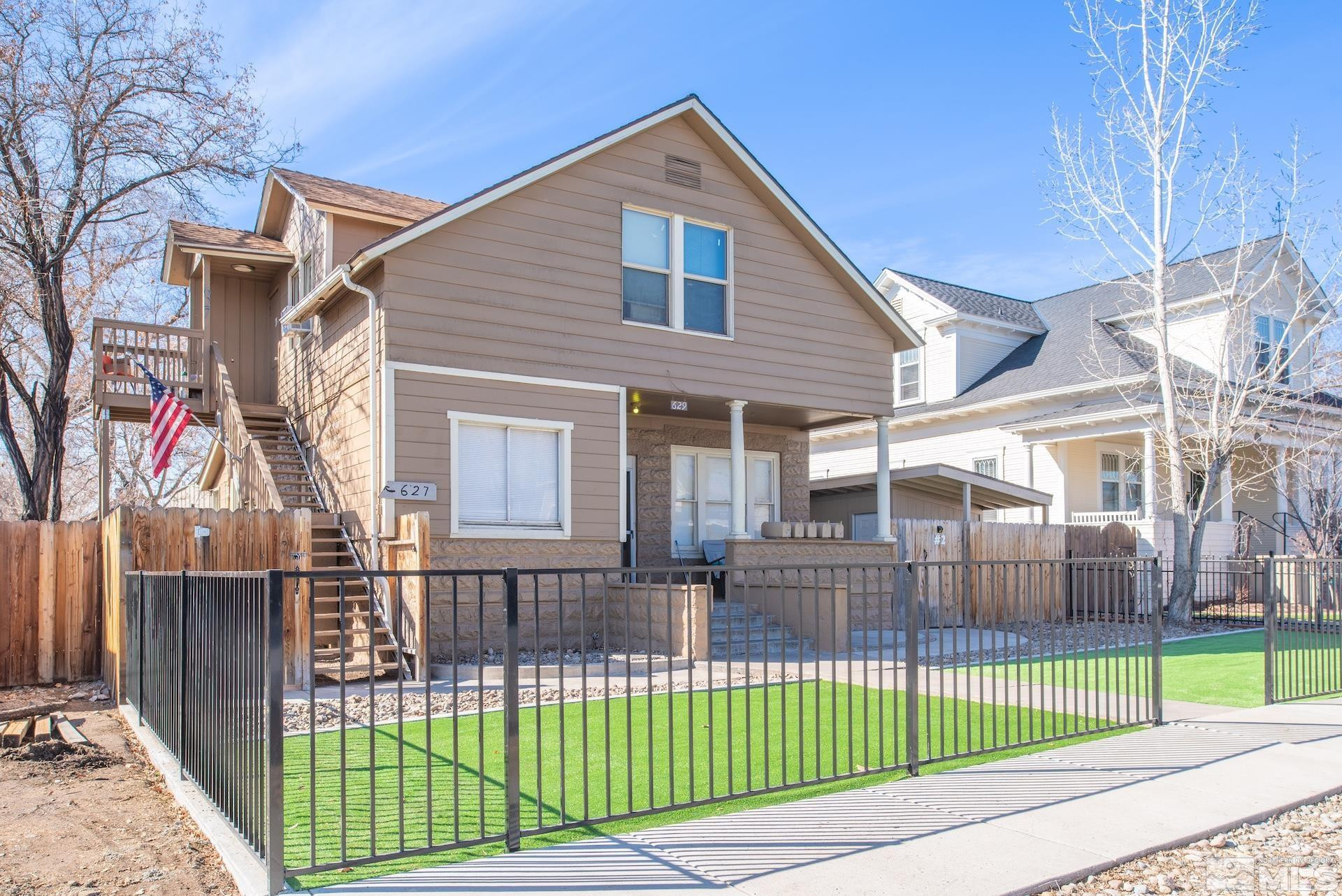 629 Sinclair Street Reno, NV 89501 - Photo 1 of 27 a view of a house with a small yard and wooden fence