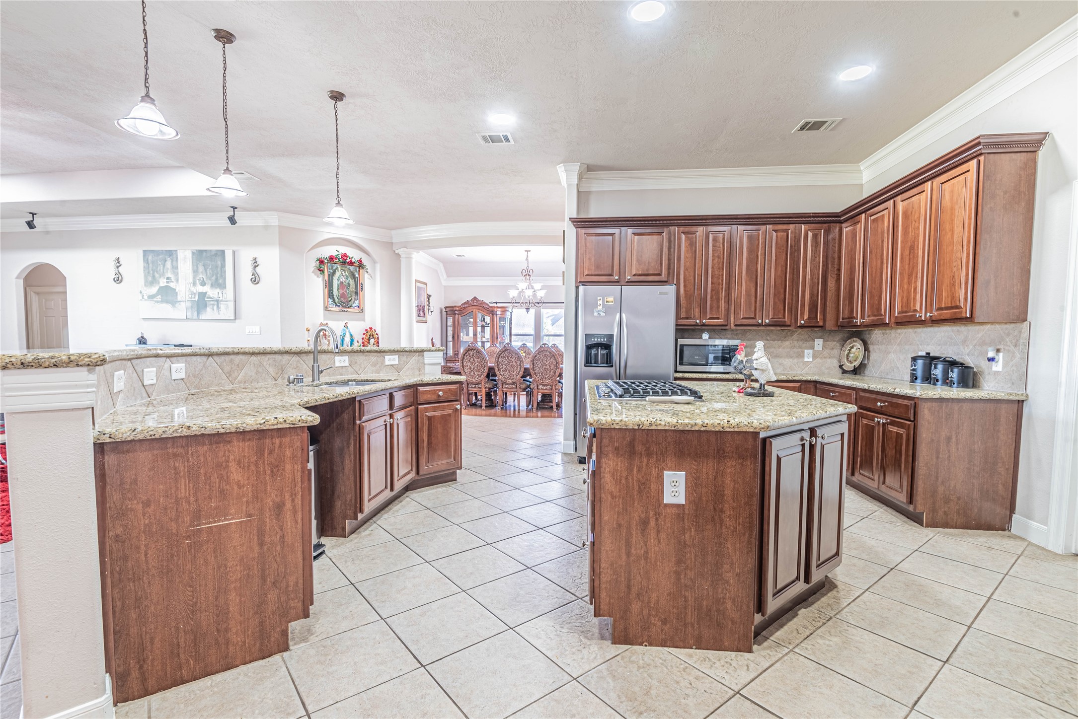 4702 Oasis Point Katy, TX 77493 - Photo 11 of 43 a kitchen with stainless steel appliances granite countertop a stove a sink and a refrigerator