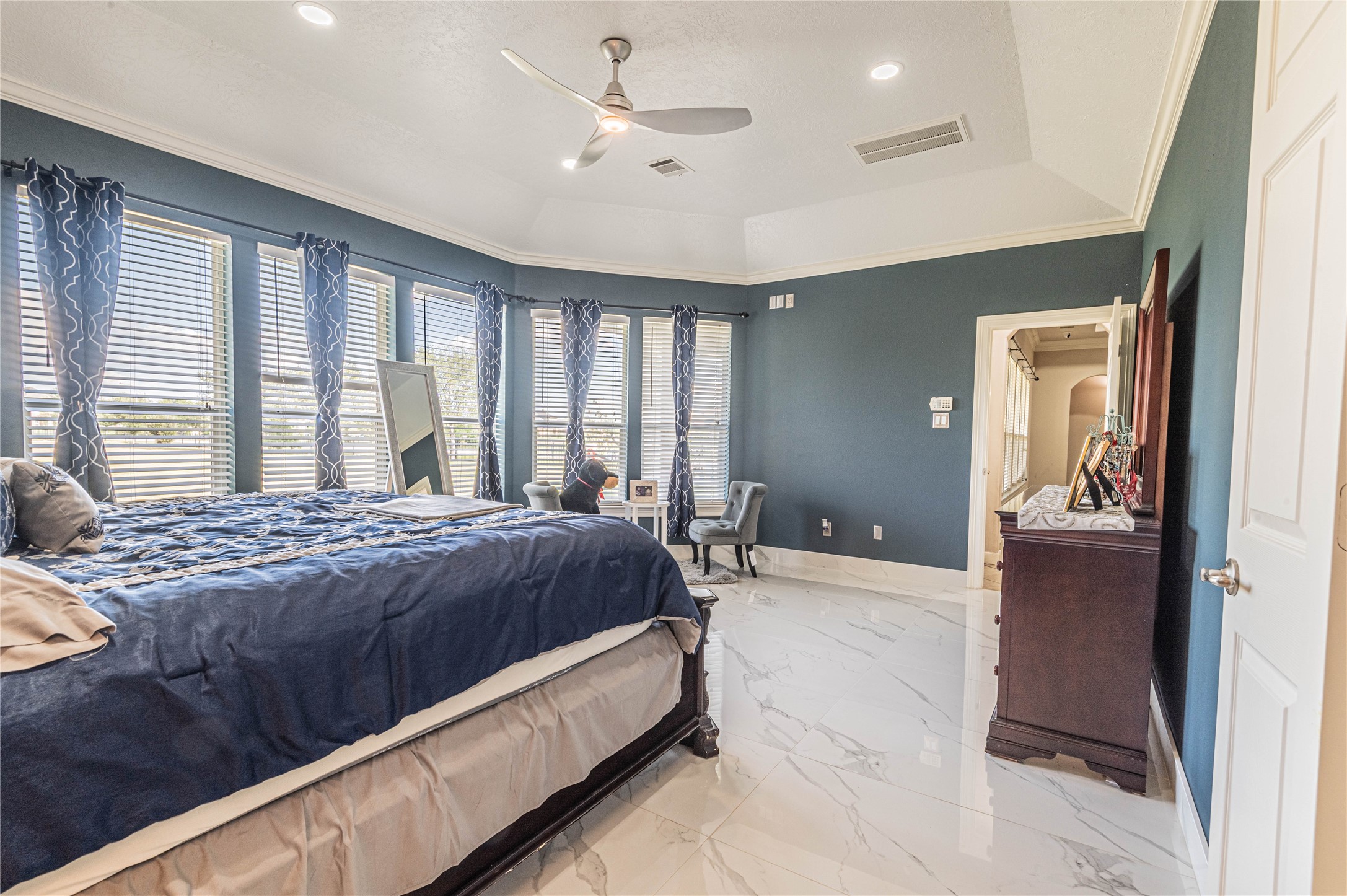 4702 Oasis Point Katy, TX 77493 - Photo 16 of 43 a spacious bedroom with a large bed and a chandelier