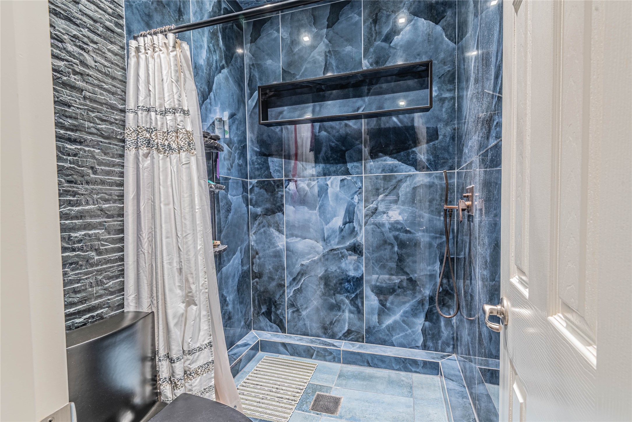 4702 Oasis Point Katy, TX 77493 - Photo 29 of 43 a bathroom with a glass shower door