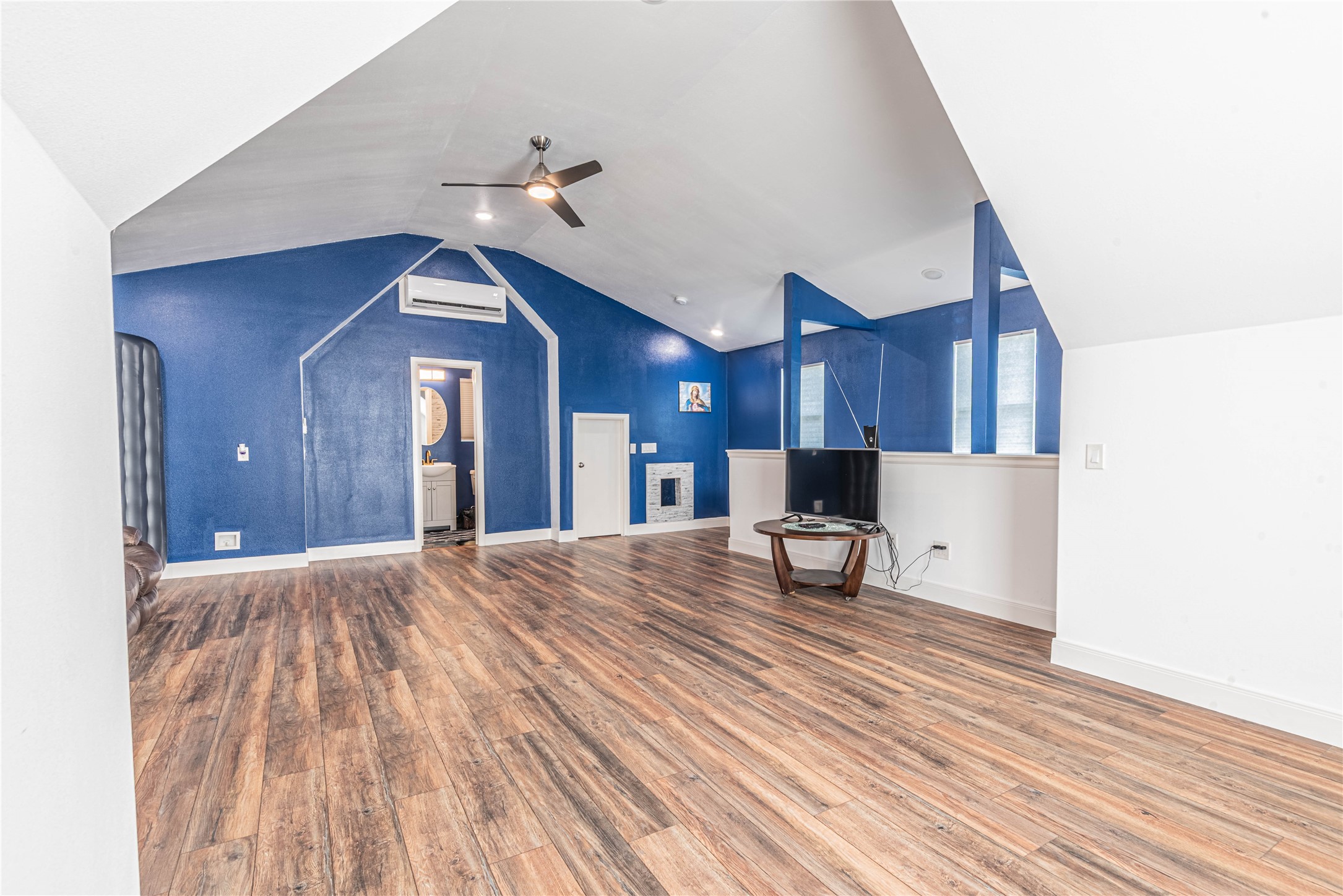 4702 Oasis Point Katy, TX 77493 - Photo 32 of 43 a view of a living room with wooden floor and a ceiling fan