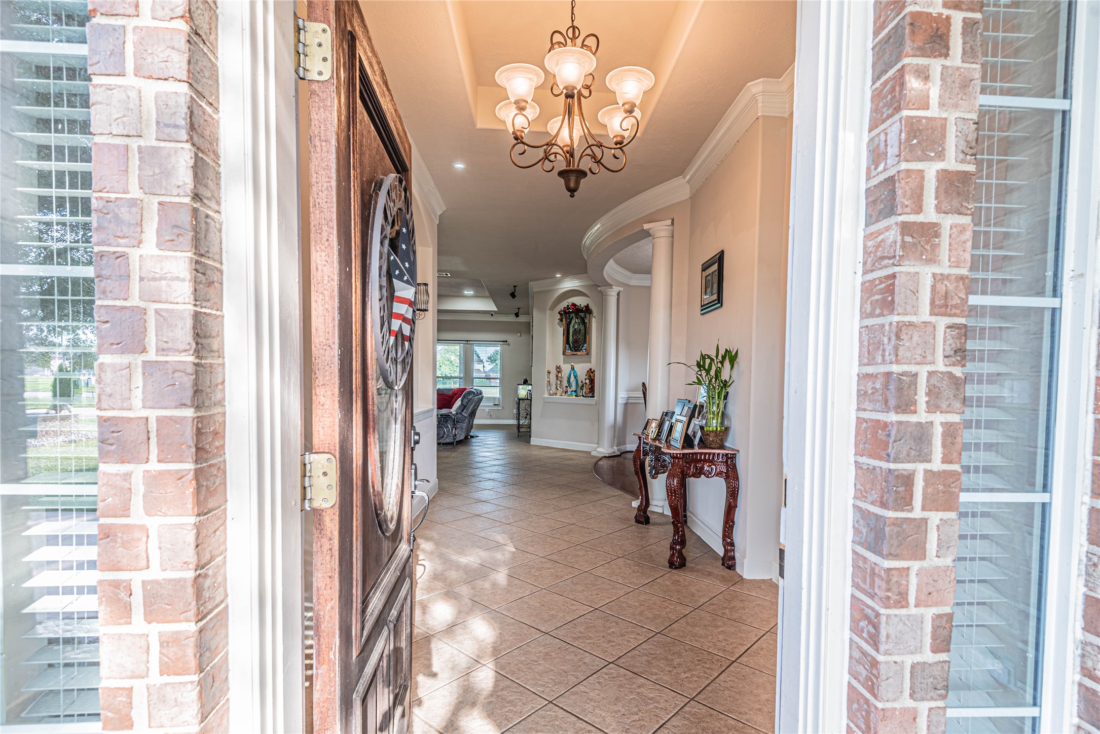 4702 Oasis Point Katy, TX 77493 - Photo 5 of 43 a view of a hallway with windows and chandelier