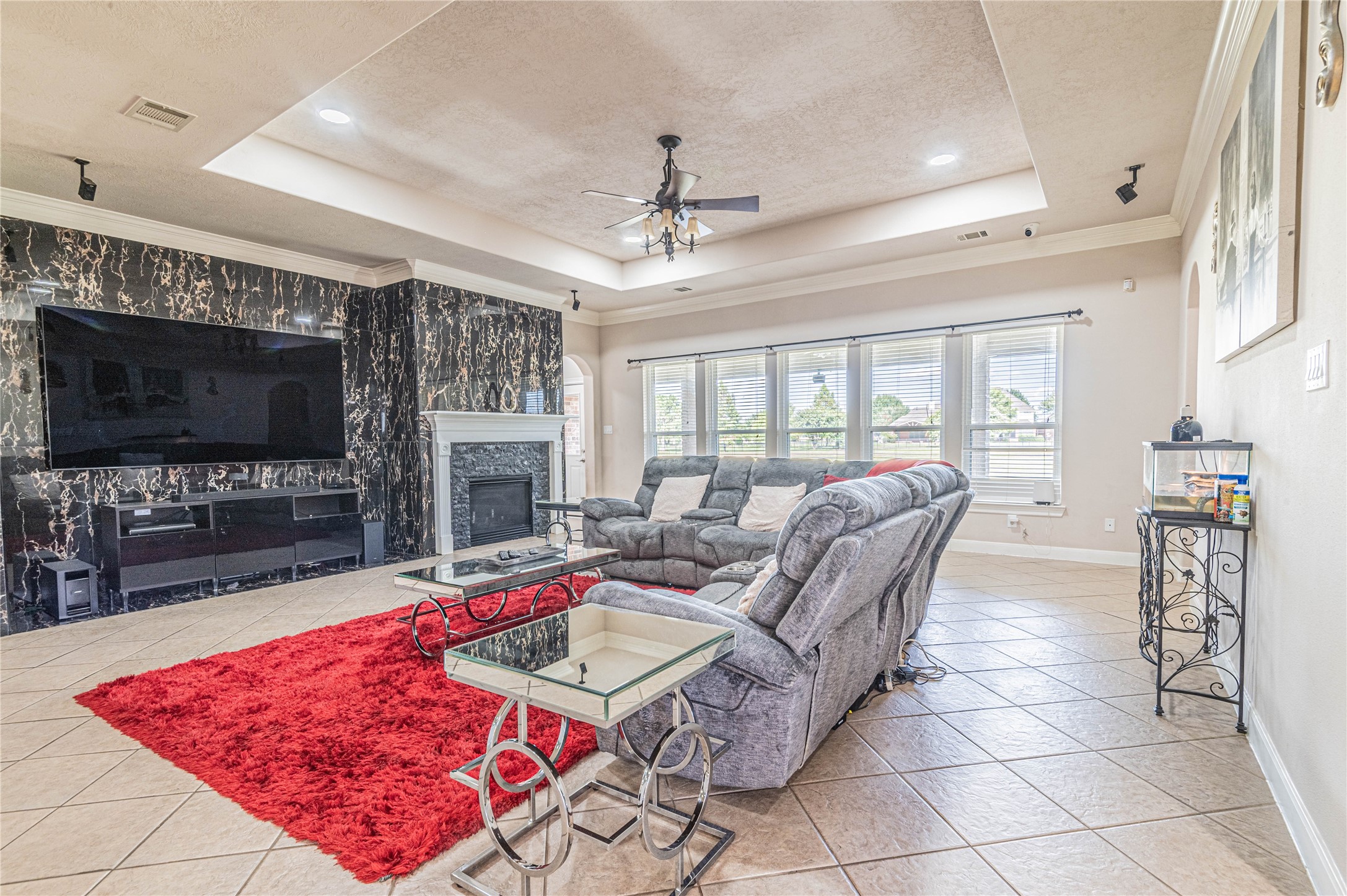 4702 Oasis Point Katy, TX 77493 - Photo 7 of 43 a living room with furniture a flat screen tv and a fireplace