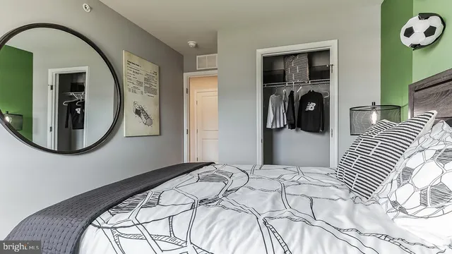 a bedroom with a bed and a mirror