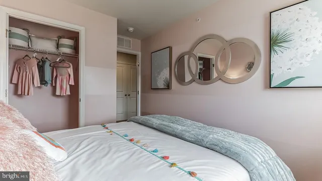 a bedroom with a bed and cabinets