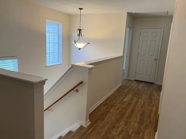 a view of a room with wooden floor and staircase
