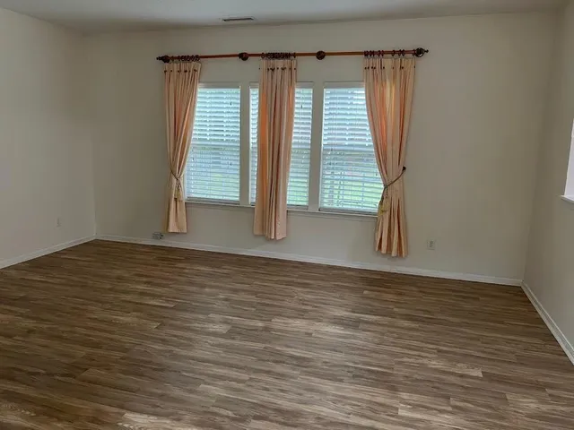 a view of an entryway with wooden floor