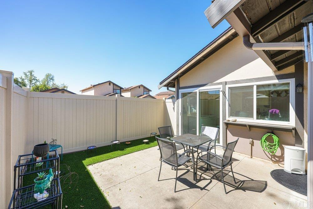 10385 Seth Way Santee, CA 92071 - Photo 13 of 33 a patio with a table and chairs and potted plants