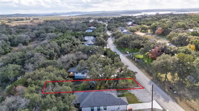 an aerial view of a house with a yard and garden