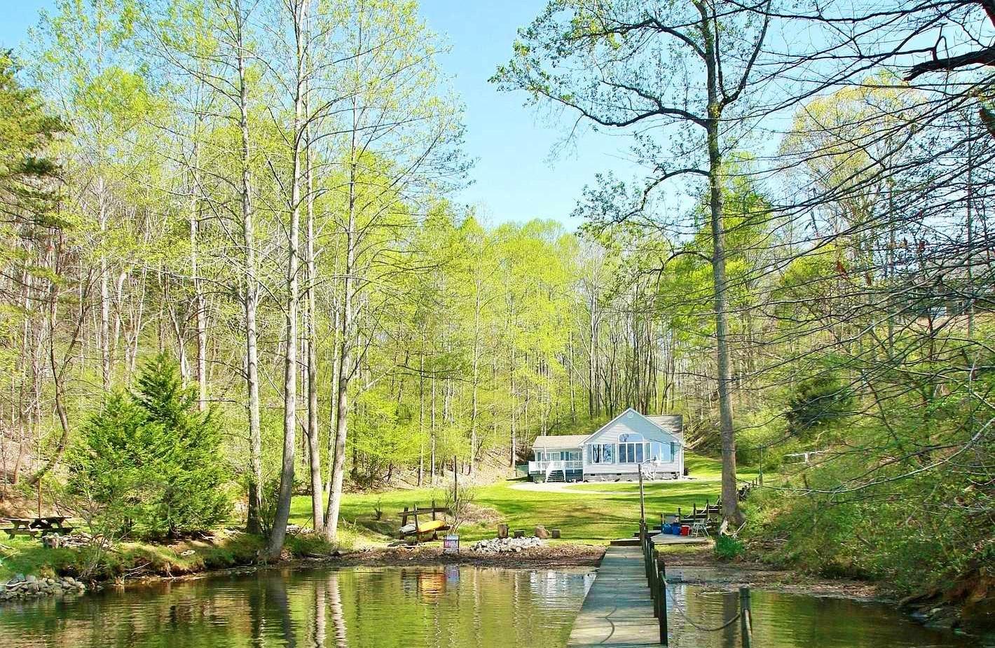 5965 Horseshoe Bend Road Goodview, VA 24095 - Photo 2 of 33 a front view of a house with a yard and lake view