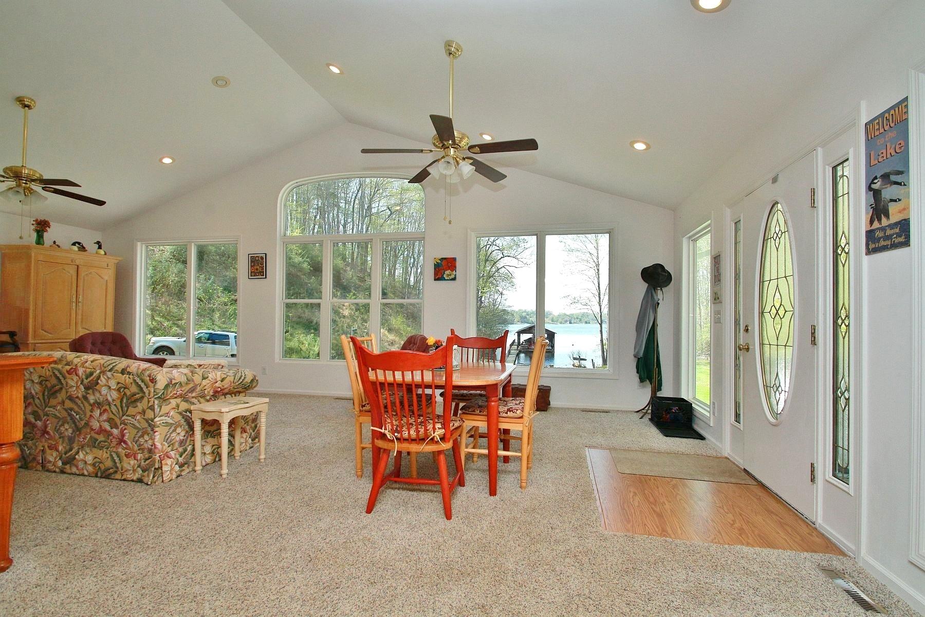 5965 Horseshoe Bend Road Goodview, VA 24095 - Photo 11 of 33 a dining room with furniture a chandelier and a rug