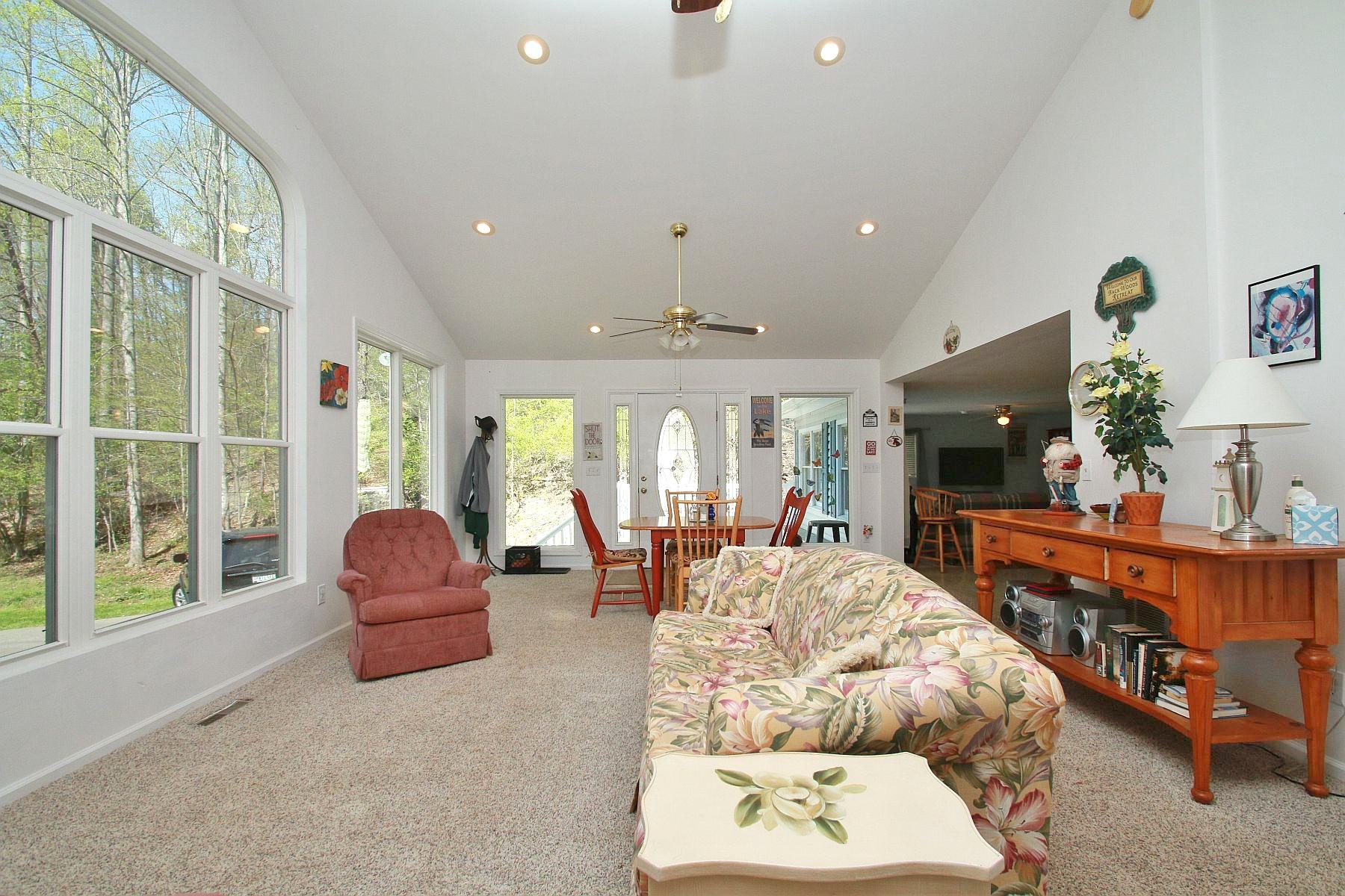 5965 Horseshoe Bend Road Goodview, VA 24095 - Photo 12 of 33 a living room with furniture a flat screen tv and a large window