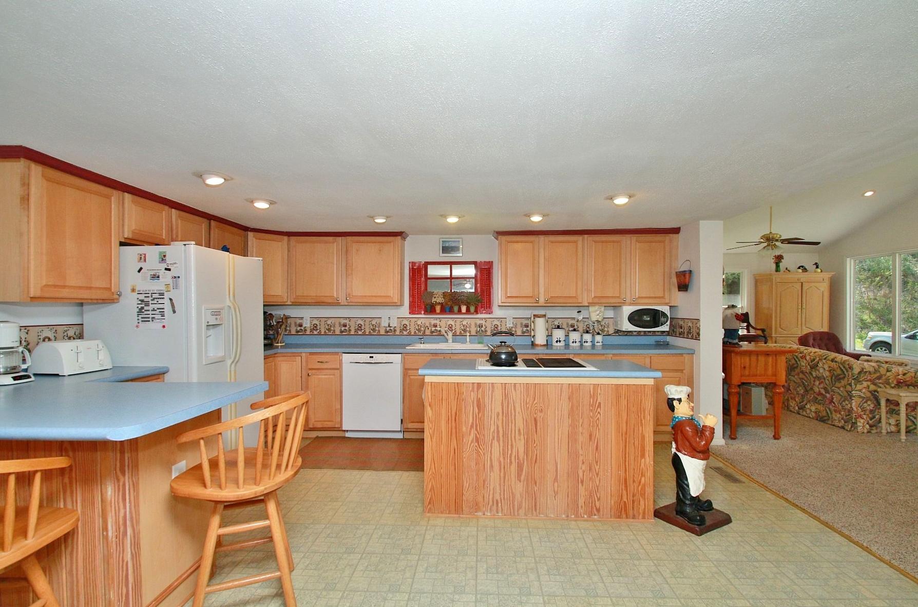 5965 Horseshoe Bend Road Goodview, VA 24095 - Photo 16 of 33 a kitchen with white cabinets and chairs