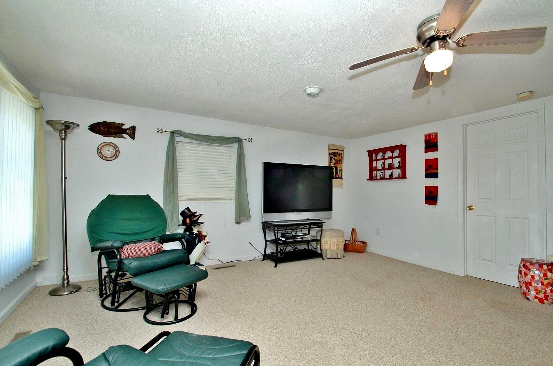 5965 Horseshoe Bend Road Goodview, VA 24095 - Photo 18 of 33 a living room with furniture and a flat screen tv