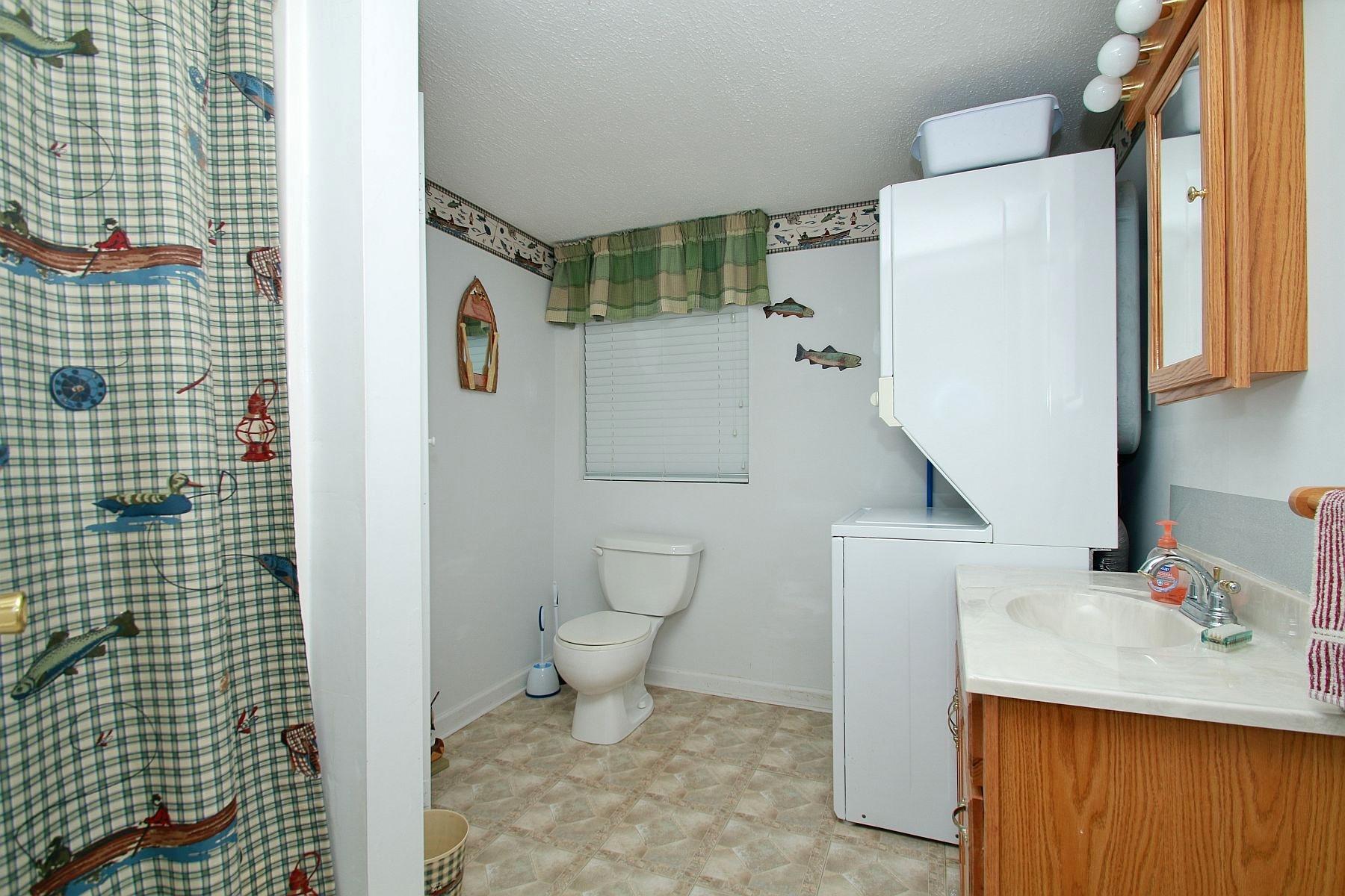 5965 Horseshoe Bend Road Goodview, VA 24095 - Photo 25 of 33 a bathroom with a sink toilet and shower