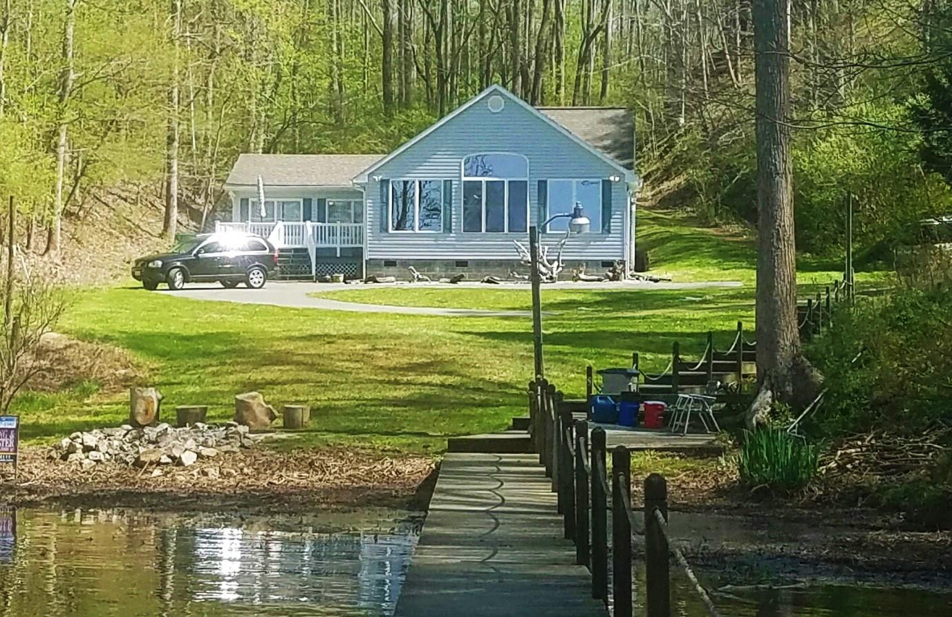 5965 Horseshoe Bend Road Goodview, VA 24095 - Photo 33 of 33 a front view of a house with a yard table and chairs