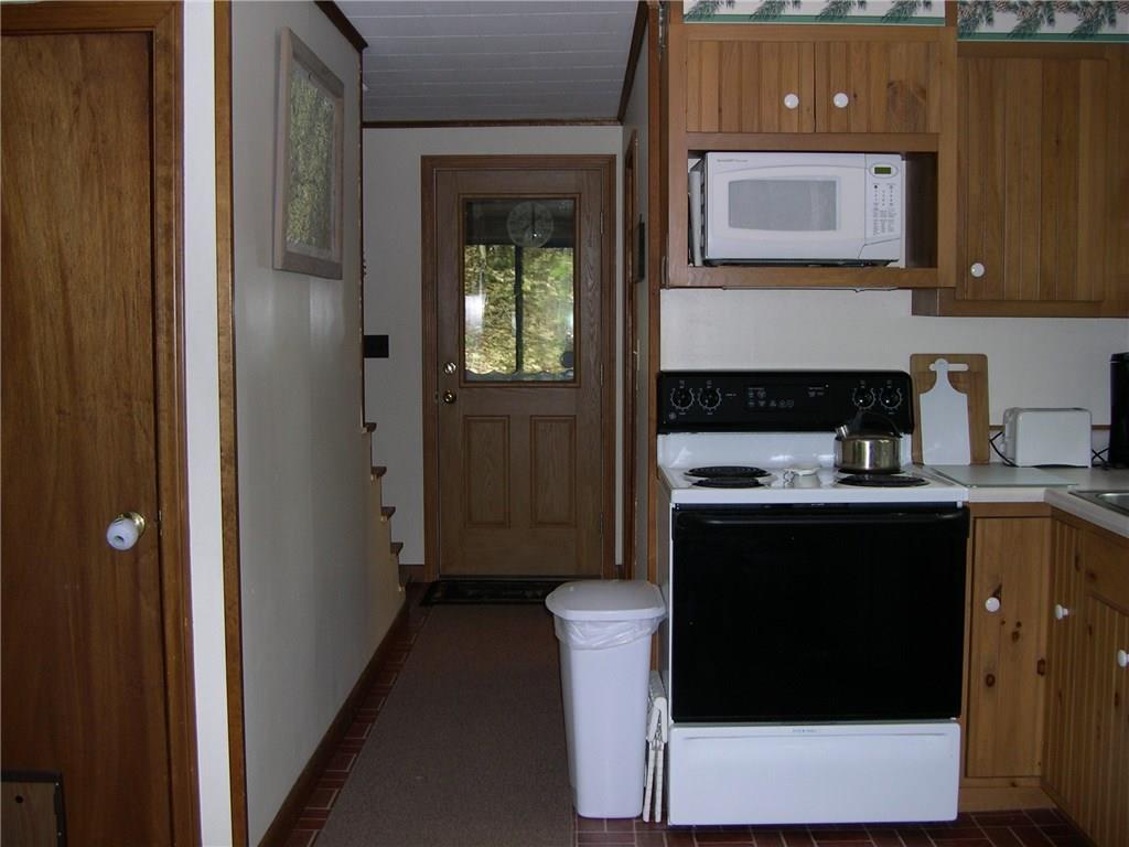 191 Edelheid Road Sandy River Plt, ME 04970 - Photo 4 of 27 basement door on left, stairs up,...