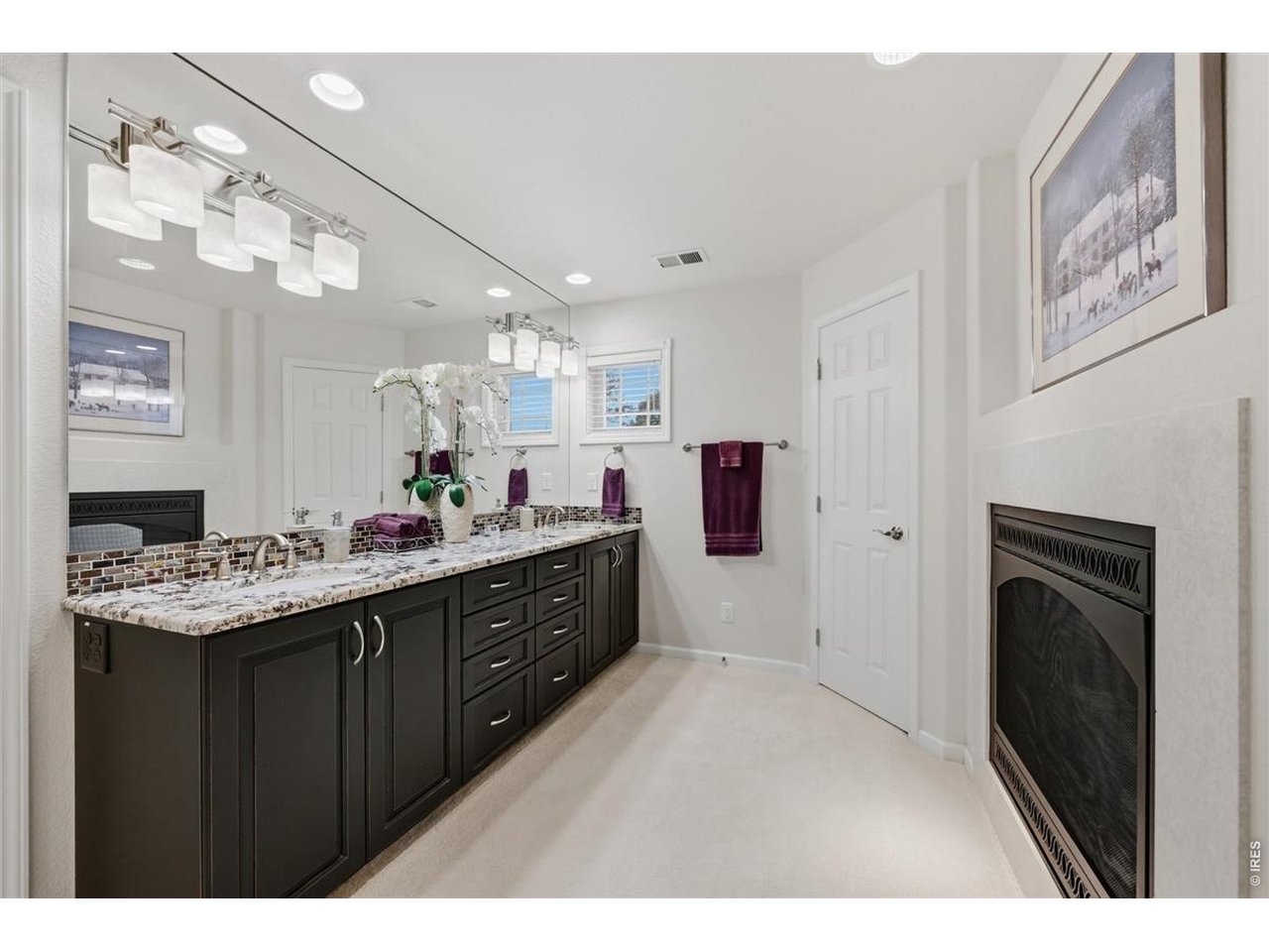3754 Kentford Road Fort Collins, CO 80525 - Photo 27 of 50 Upper primary bath with expansive granite vanity, abundant cabinetry & two-sided gas fireplace