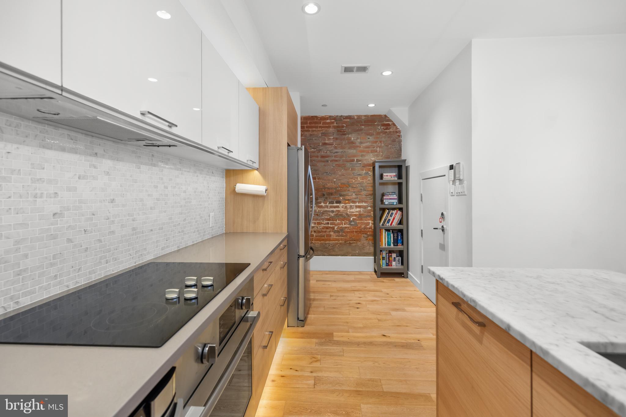 1324 W Street Northwest, Unit 1 Washington, DC 20009 - Photo 11 of 37 a kitchen with stainless steel appliances granite countertop a stove and a refrigerator