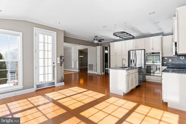a large white kitchen with cabinets