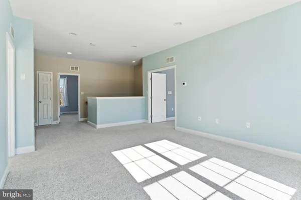 a view of a big room with wooden floor and cabinet
