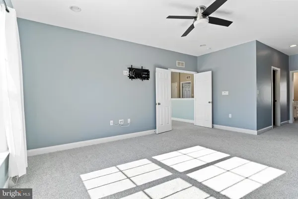 a view of livingroom with hardwood floor and a ceiling fan