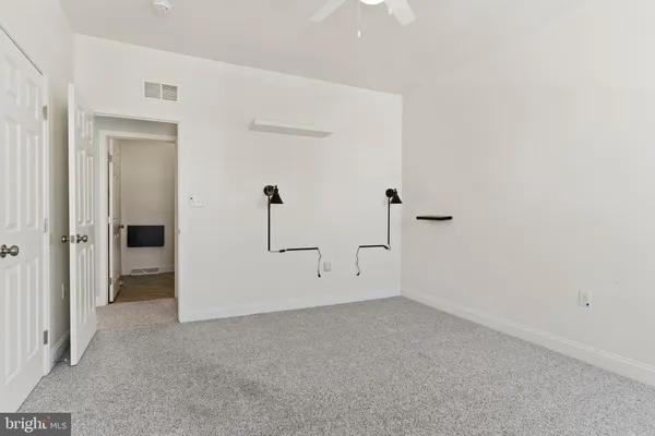 a bathroom with a toilet a sink and a mirror