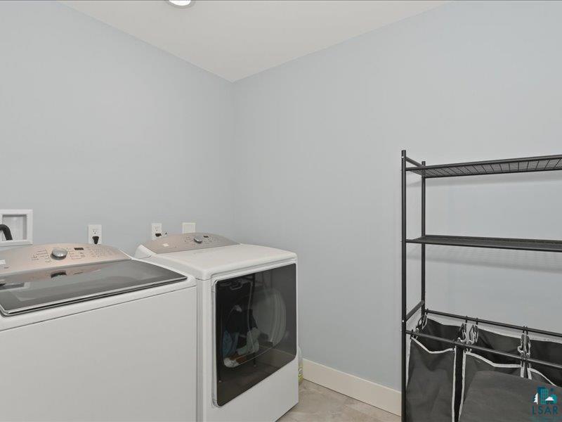 88440 Huron Street Cornucopia, WI 54827 - Photo 23 of 44 Laundry area with light gray walls, white baseboards, and a ceiling-mounted light fixture.