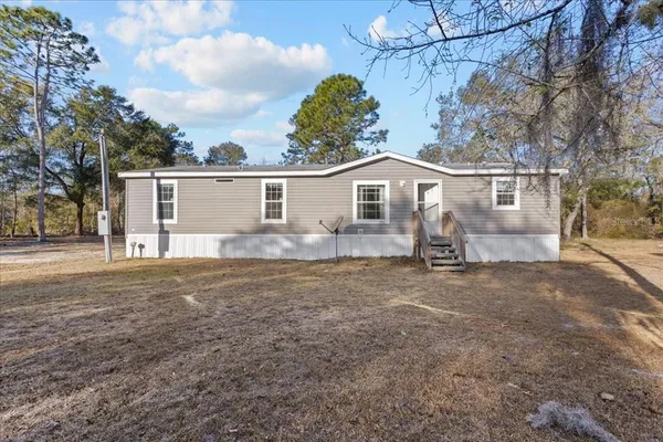 a view of a house with a backyard