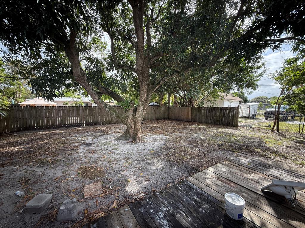 1724 Northeast 50th Court Pompano Beach, FL 33064 - Photo 12 of 13 a backyard of a house with lots of green space