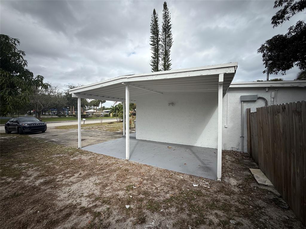 1724 Northeast 50th Court Pompano Beach, FL 33064 - Photo 2 of 13 a view of a parking space in front of a house