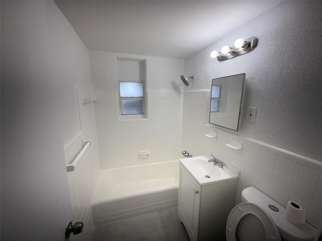 1724 Northeast 50th Court Pompano Beach, FL 33064 - Photo 5 of 13 a bathroom with a sink a toilet and shower
