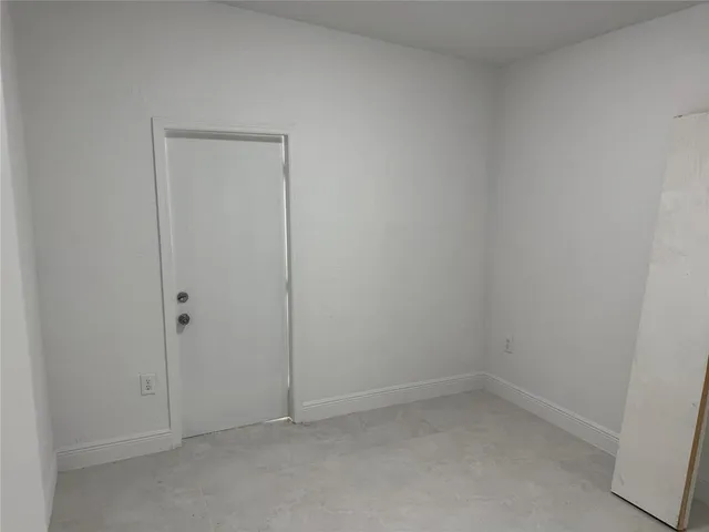 an empty room with windows and entrance