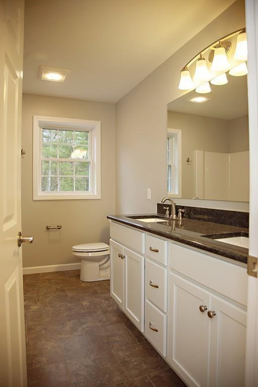 Lot 12 Crow Hill Road Monson, MA 01057 - Photo 16 of 19 a bathroom with a granite countertop toilet a sink and a mirror